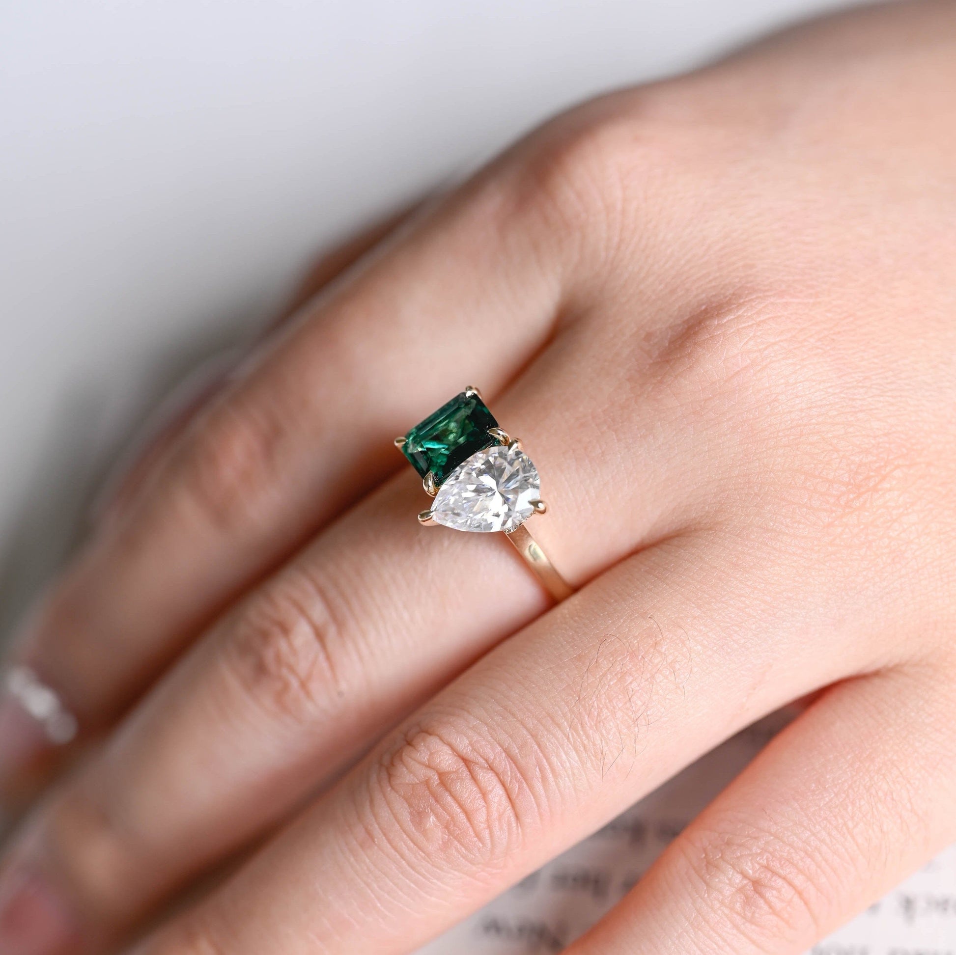 SquareJewelry emerald cut lab grown emerald engagement ring Hidden Halo Toi et Moi Lab Grown Emerald & Pear Moissanite Engagement Ring