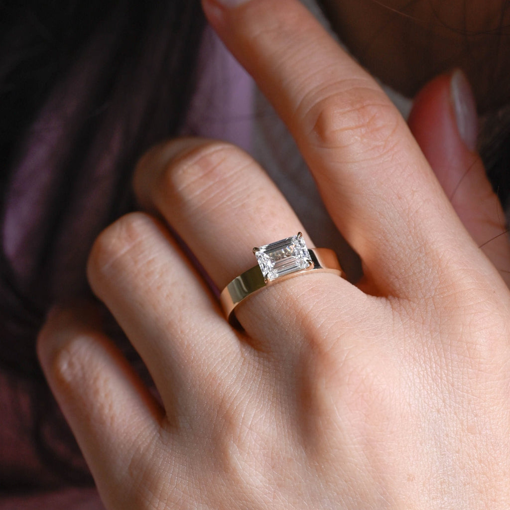 SquareJewelry emerald cut moissanite engagement ring East-West Wide Band Emerald Cut Moissanite Engagement Ring